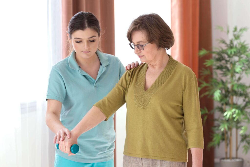 Caregiver helping elderly woman walk safely indoors, offering companion care and mobility assistance in Bergen County, NJ