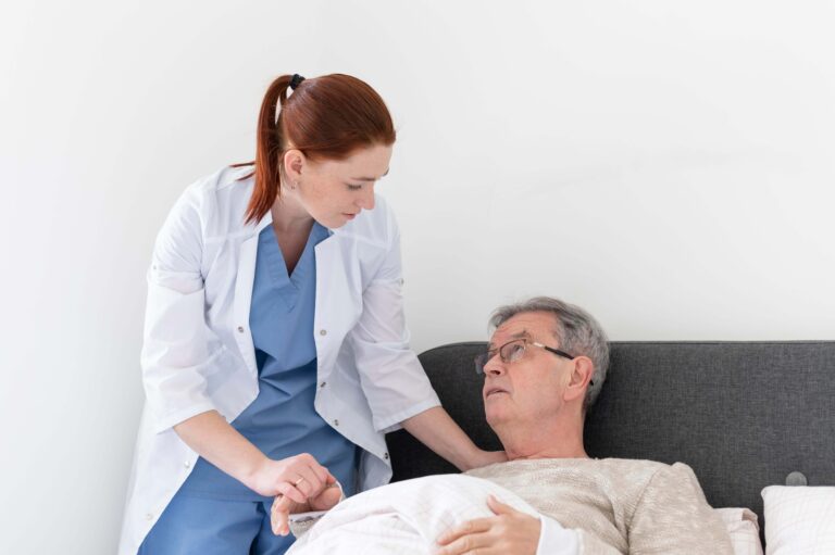 Caregiver assisting a senior woman in bed with daily personal care and hygiene support at home in Bergen County, NJ